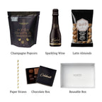 Flat lay of Cheers!, showing all 5 items included in the box, including the Cordon Negro Brut Cava, The Champagne Popcorn and Container.