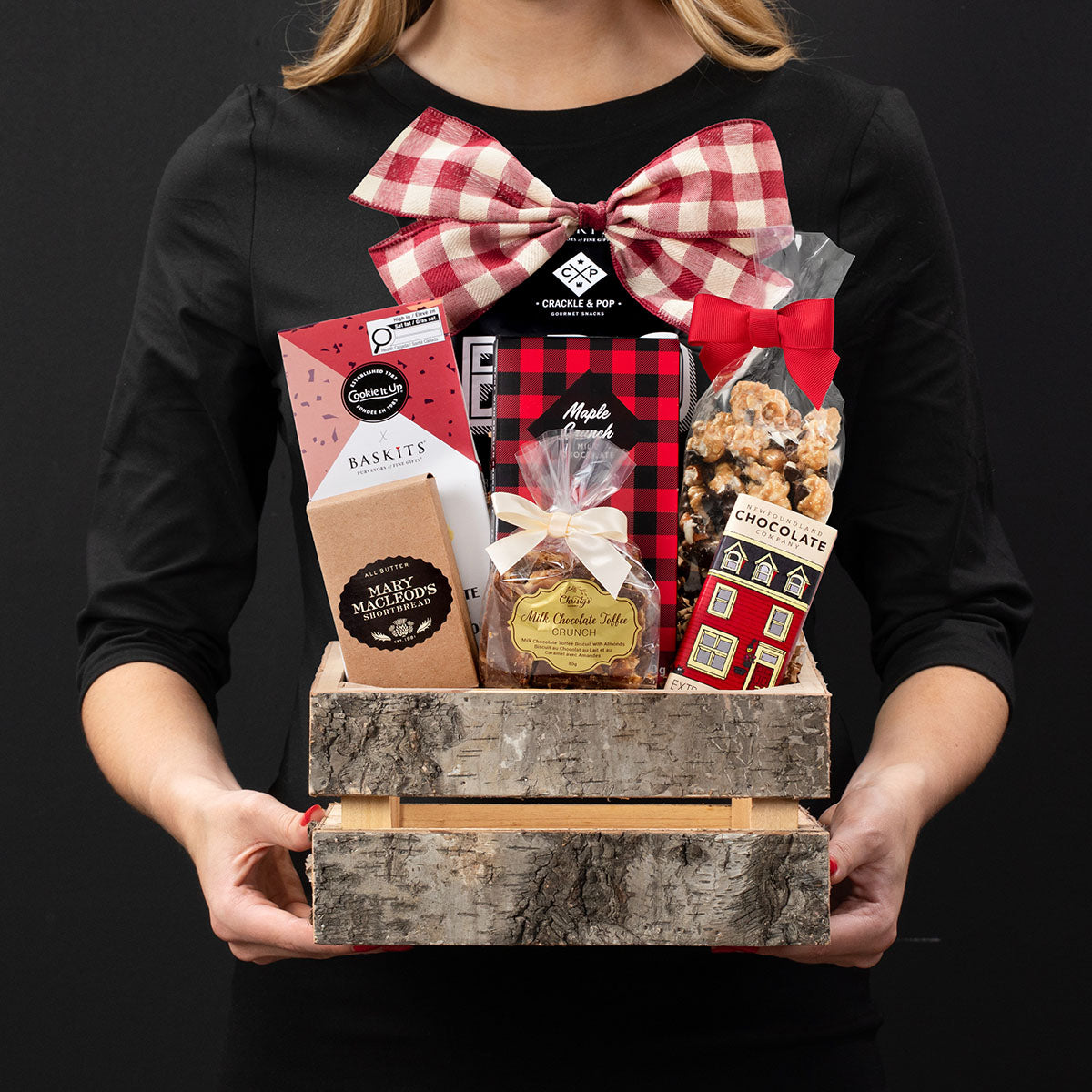 The Canadiana L gourmet gift box held by a person in a black shirt to show size and scale.