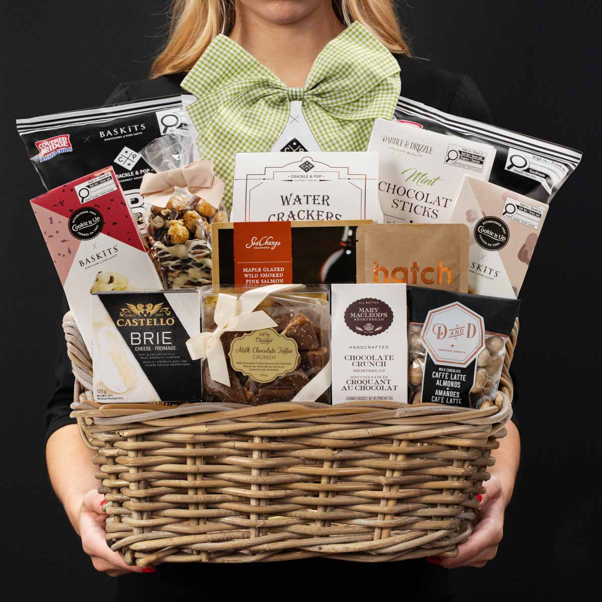 The Forest Hill gourmet gift basket held by a person in a black shirt to show size and scale.