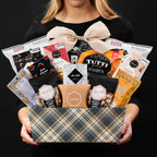 The Kosher XL gourmet gift basket held by a person in a black shirt to show size and scale basket.