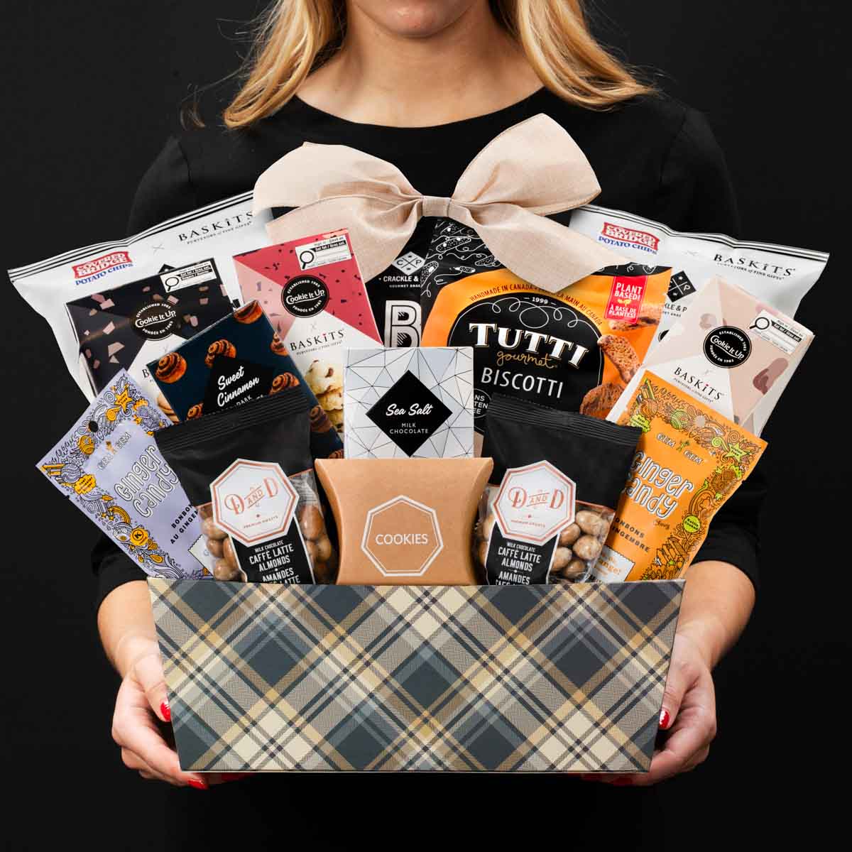 The Kosher XL gourmet gift basket held by a person in a black shirt to show size and scale basket.