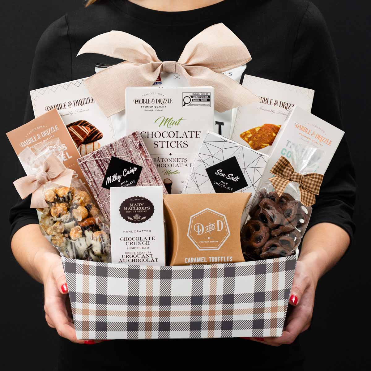 The Champlain M gourmet gift box held by a person in a black shirt to show size and scale.