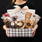 The Champlain XL gourmet gift basket held by a person in a black shirt to show size and scale.