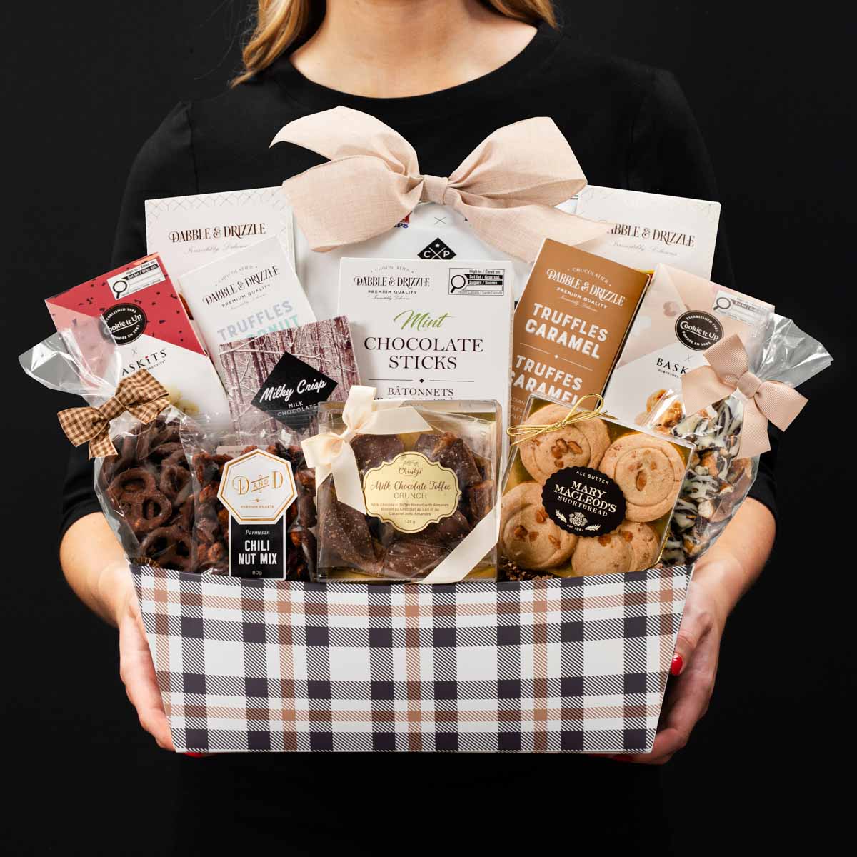 The Champlain XL gourmet gift basket held by a person in a black shirt to show size and scale.