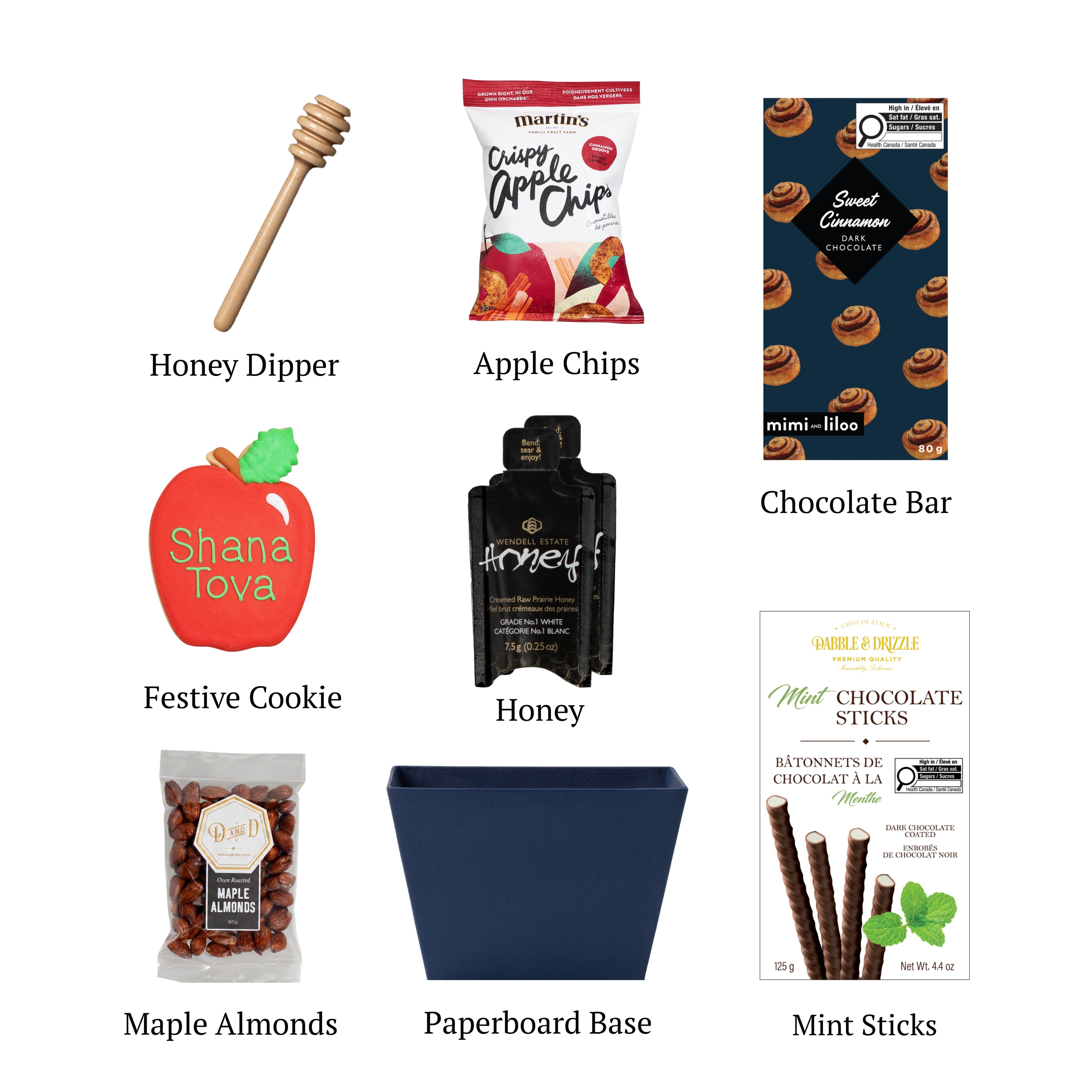 Days of Awe flat lay displaying a blue paperboard base, gourmet apple chips, a hand-painted apple-shaped cookie, honey and chocolate treats.