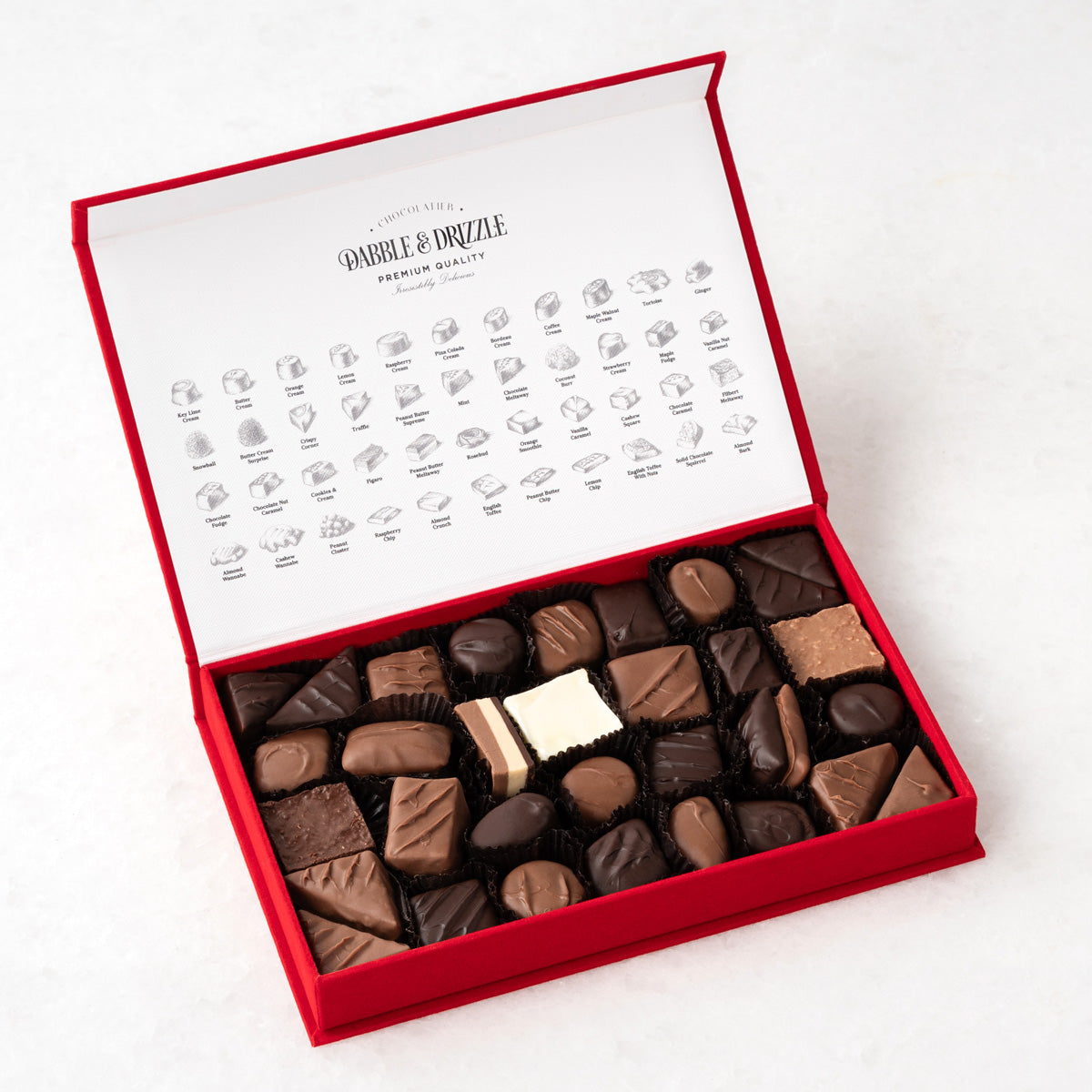 Flat lay of Heavenly Bites (M), showing all Over Two Dozen Chocolates items included in the box