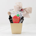 Rosh Hashanah gift basket with gourmet honey, apple chips, a hand-painted apple-shaped cookie and chocolate treats.