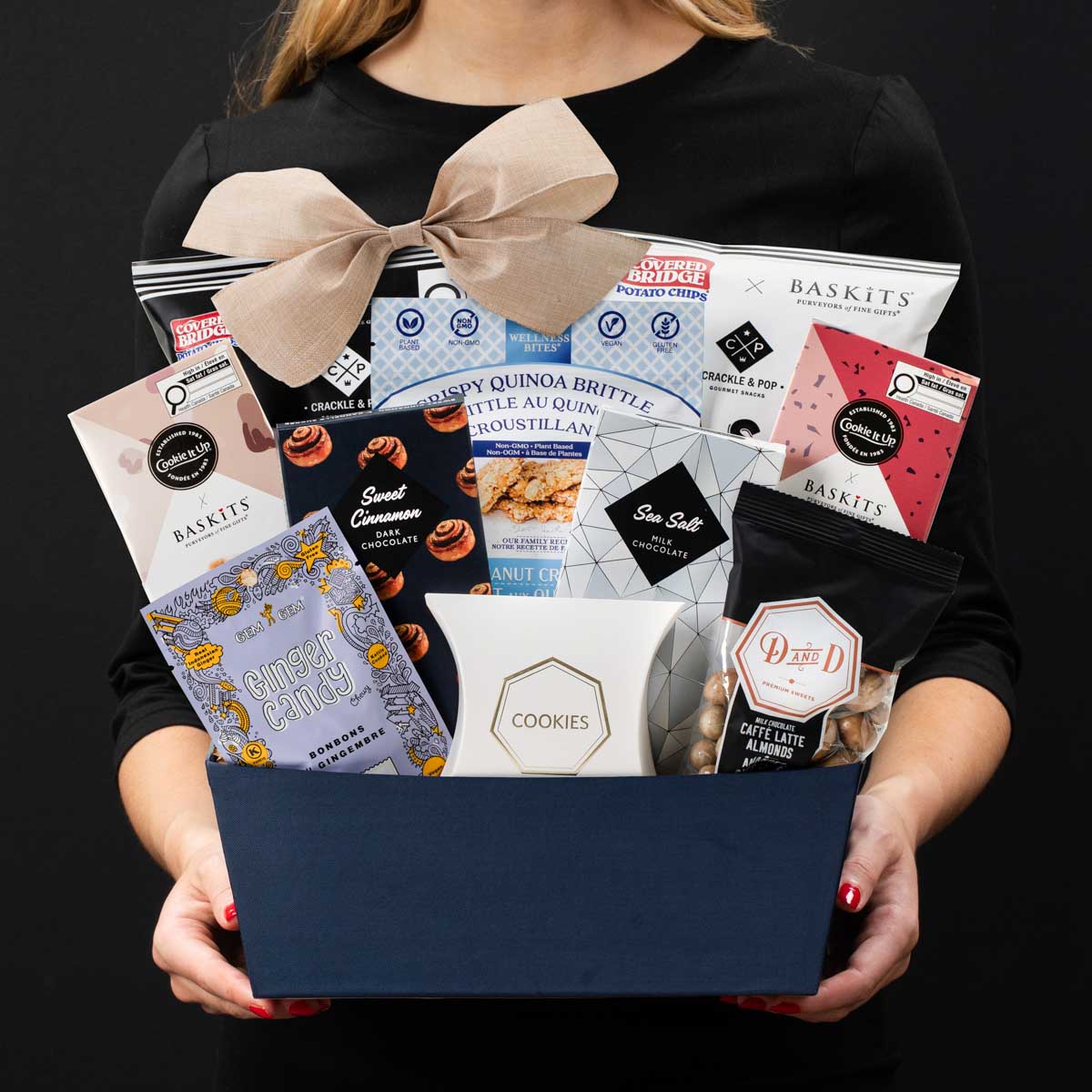 The Kosher L gourmet gift basket held by a person in a black shirt to show size and scale.