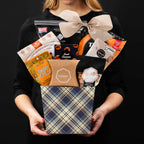 The Kosher M gourmet gift basket held by a person in a black shirt to show size and scale.
