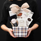 The Richmond gourmet gift basket, held by a person in a black shirt to show size and scale