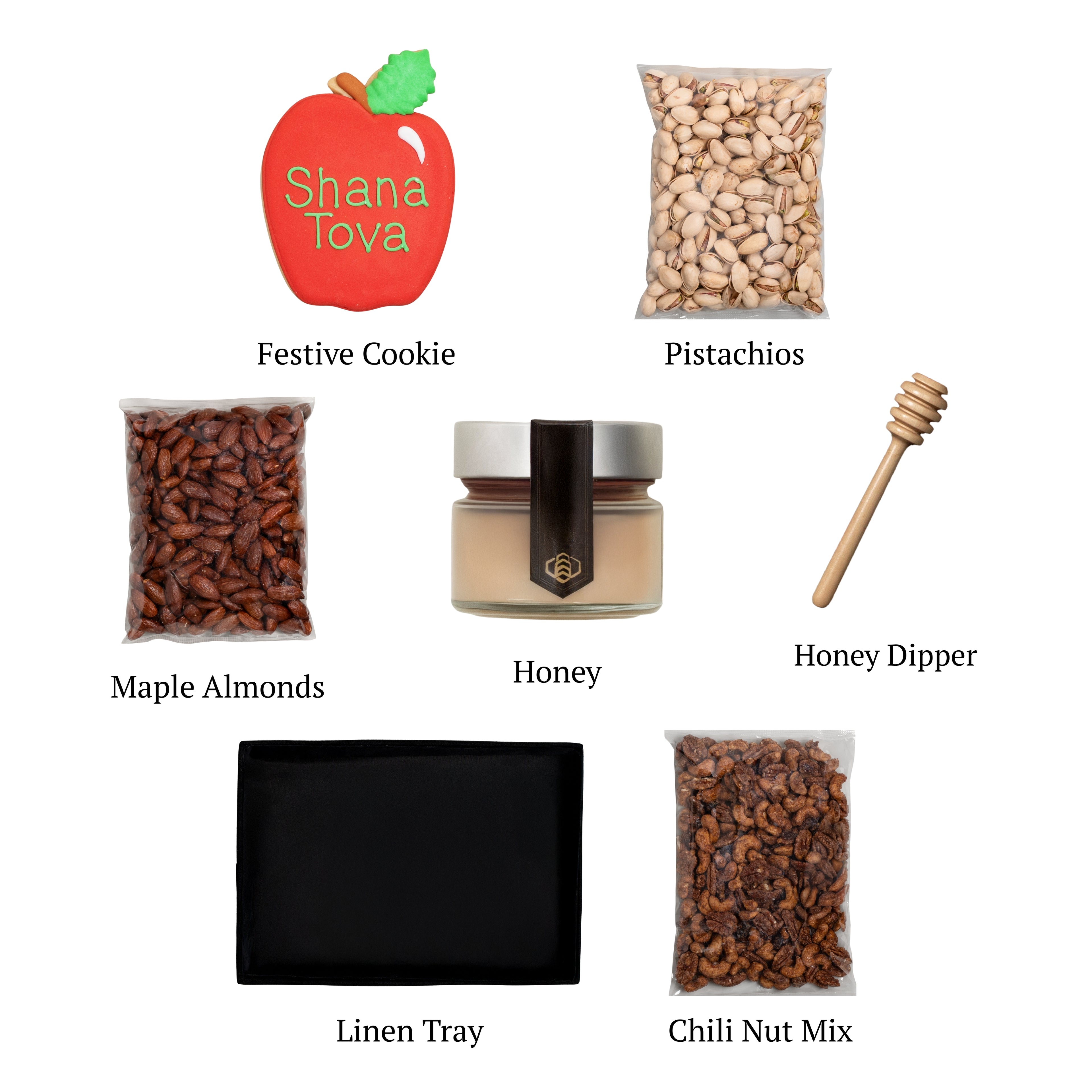 Sweet Harvest Nut Tray flat lay, displaying a black linen tray, alongside gourmet raw honey, a hand-painted apple-shaped cookie, and nut treats.