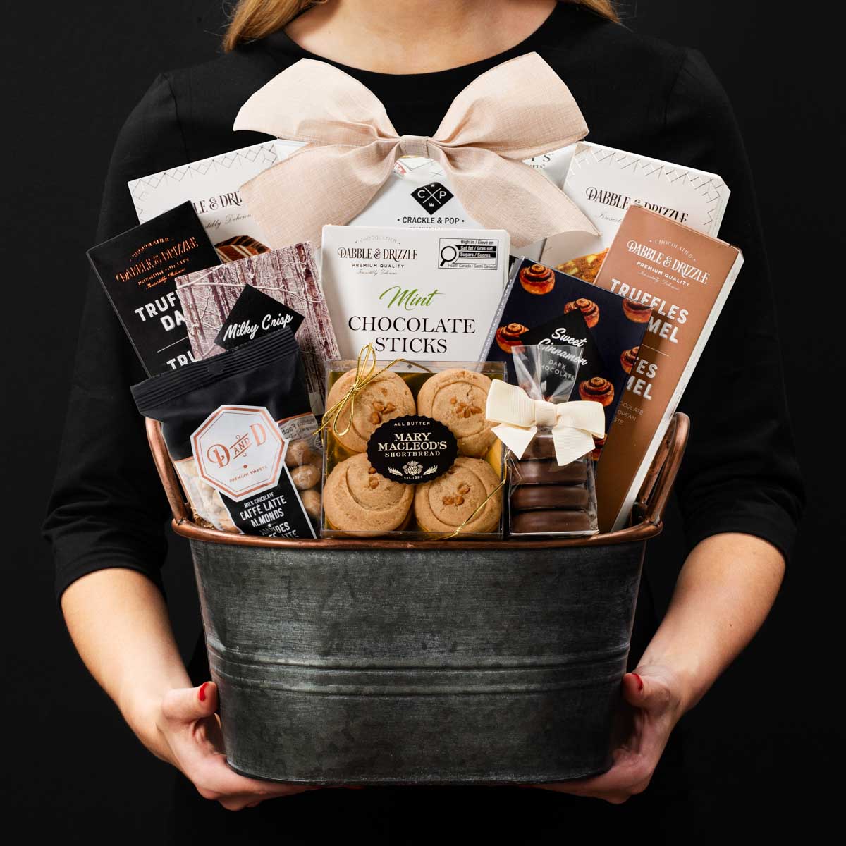 The Champlain L  gourmet gift basket held by a person in a black shirt to show size and scale.