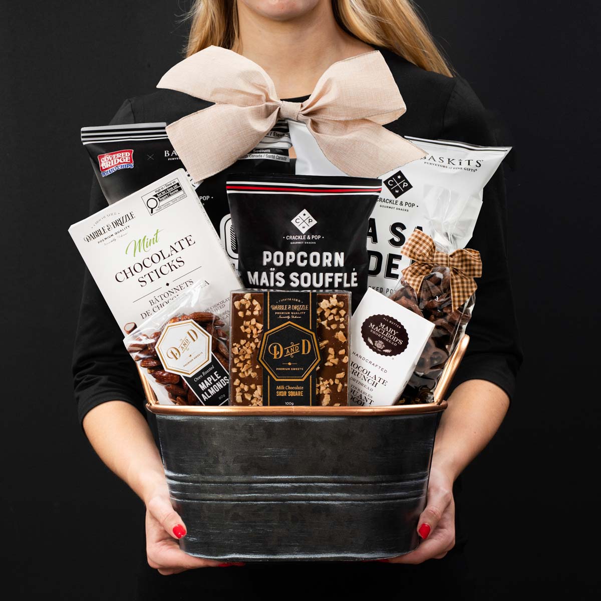 The Champlain S gourmet gift box held by a person in a black shirt to show size and scale.