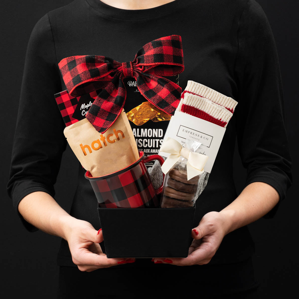 The Just For You gourmet gift box held by a person in a black shirt to show size and scale.