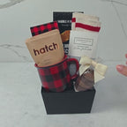 Hands unpacking a 7-piece Just For You gift basket, displaying our signature Dabble & Drizzle Butter Almond Biscuits, and an array of curated indulgences.