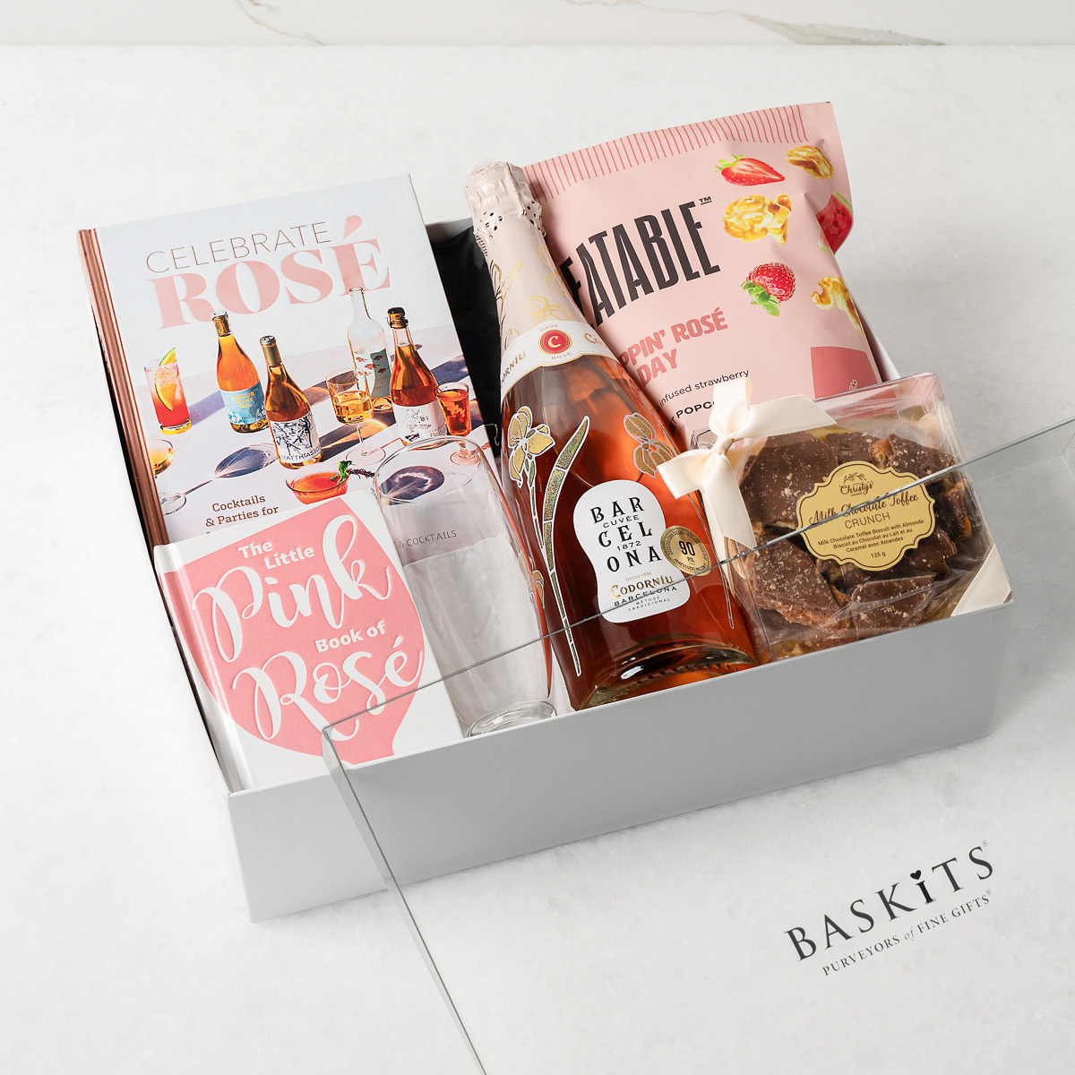 Gift box filled with sweet treats and a Rose bottle